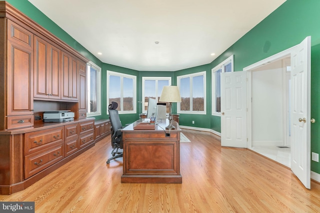 office space featuring recessed lighting, baseboards, and light wood-style flooring