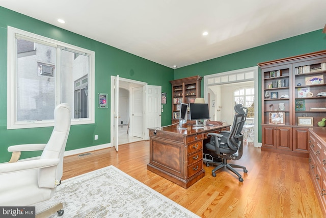 office area featuring light wood-style flooring, recessed lighting, baseboards, and visible vents