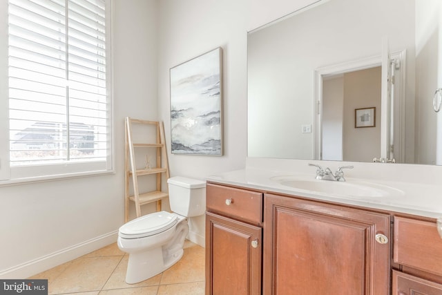 half bathroom featuring vanity, tile patterned floors, toilet, and baseboards