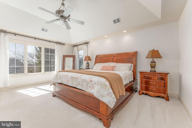 bedroom with visible vents, lofted ceiling, light colored carpet, and a ceiling fan