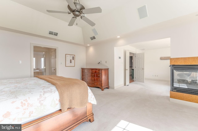 bedroom featuring lofted ceiling, light colored carpet, visible vents, and baseboards