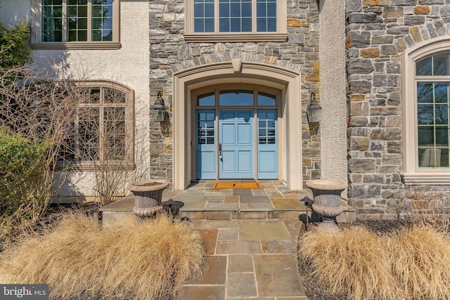 entrance to property with stone siding