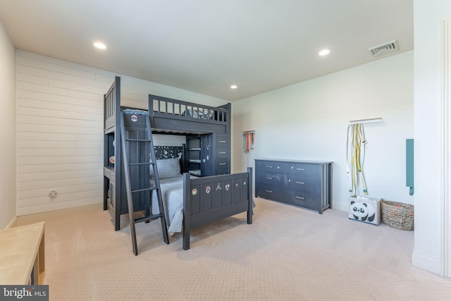 carpeted bedroom with recessed lighting, visible vents, and wood walls