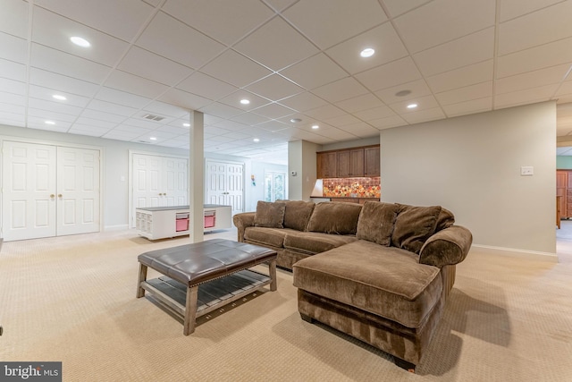 living area with recessed lighting, visible vents, baseboards, and light colored carpet