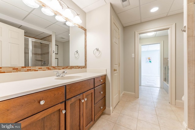 full bath with vanity, visible vents, a stall shower, tile patterned flooring, and a paneled ceiling