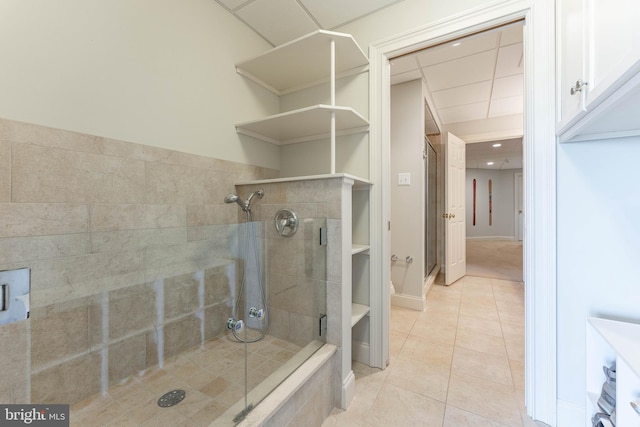 bathroom with tile patterned floors and a stall shower