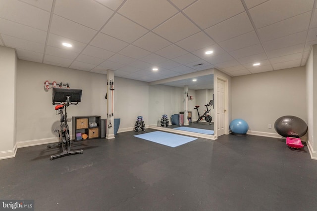 workout room with recessed lighting, baseboards, and a drop ceiling