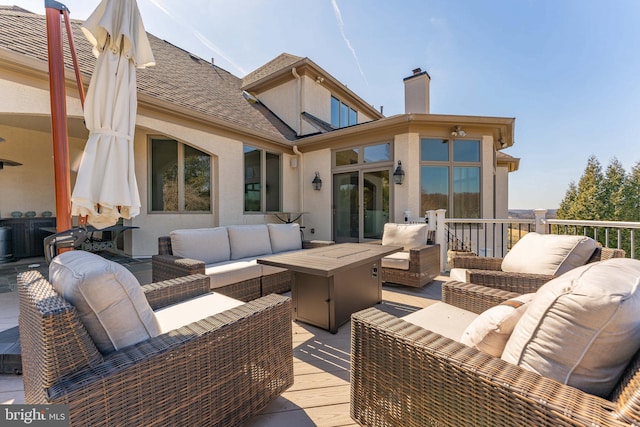 wooden terrace featuring an outdoor hangout area