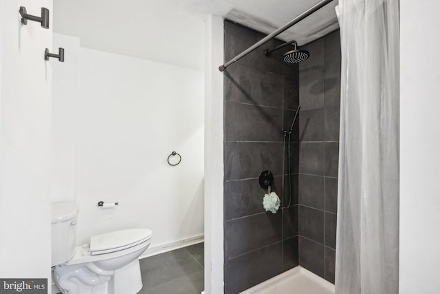 bathroom featuring walk in shower and toilet