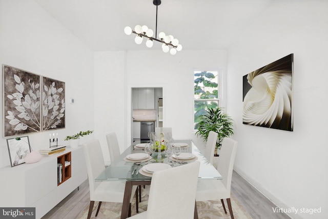 dining room featuring a chandelier and light hardwood / wood-style flooring