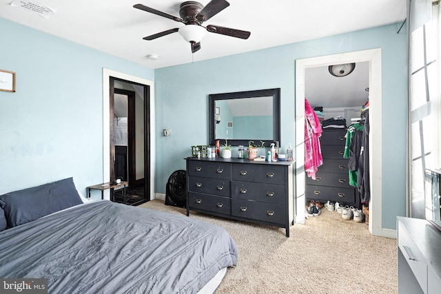 carpeted bedroom featuring ceiling fan and a closet