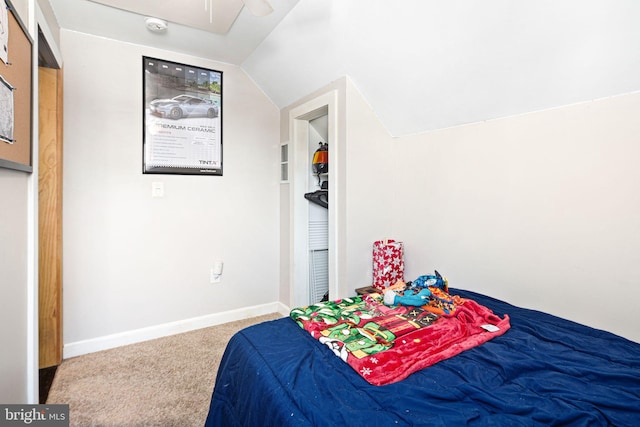 bedroom featuring vaulted ceiling and carpet floors