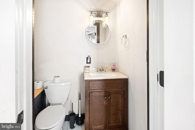 bathroom featuring vanity and toilet