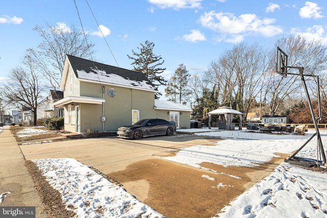 view of snowy exterior featuring a gazebo