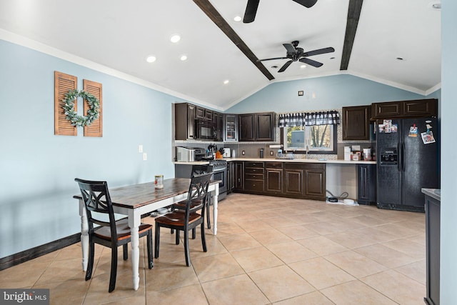 tiled dining space with ornamental molding, lofted ceiling, sink, and ceiling fan