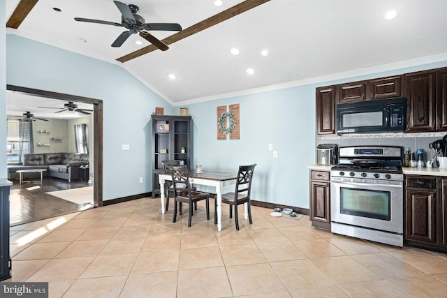 kitchen featuring gas stove, lofted ceiling, light tile patterned flooring, and dark brown cabinetry