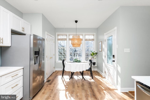 dining space with light hardwood / wood-style flooring