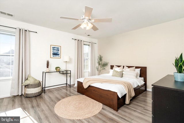 bedroom with hardwood / wood-style floors and ceiling fan