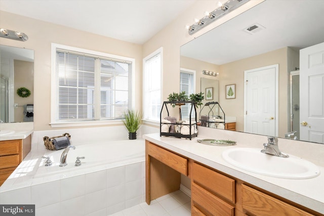 bathroom featuring vanity, shower with separate bathtub, and tile patterned floors