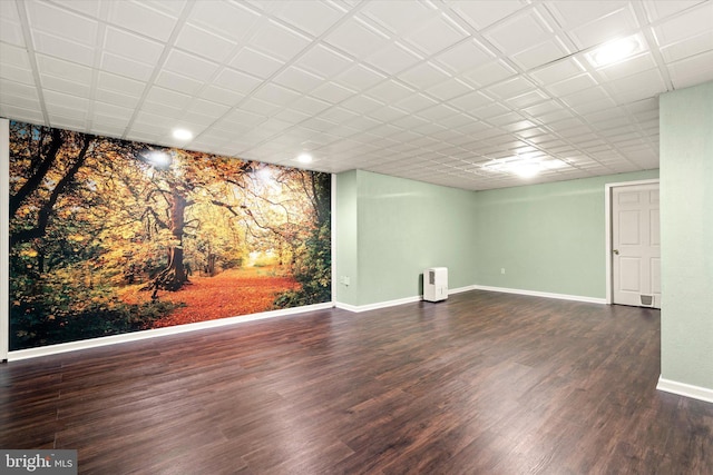 basement with dark hardwood / wood-style floors