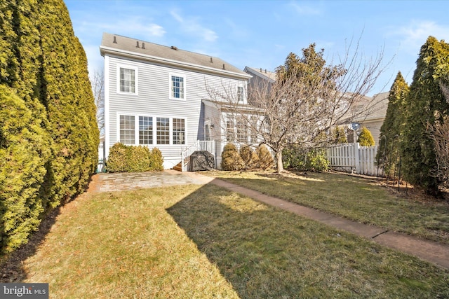 back of house featuring a yard