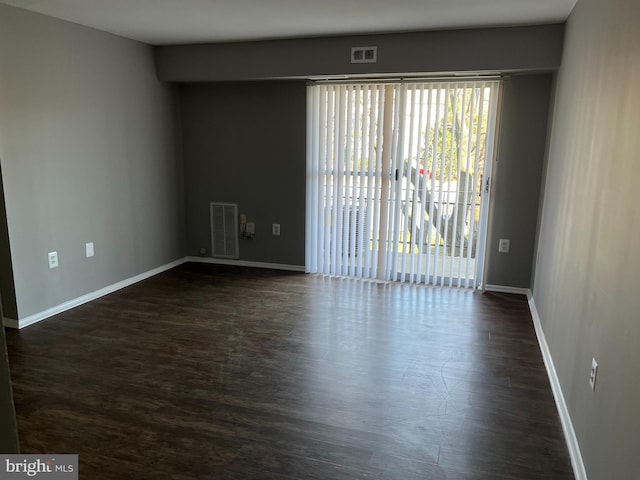 spare room with dark hardwood / wood-style floors