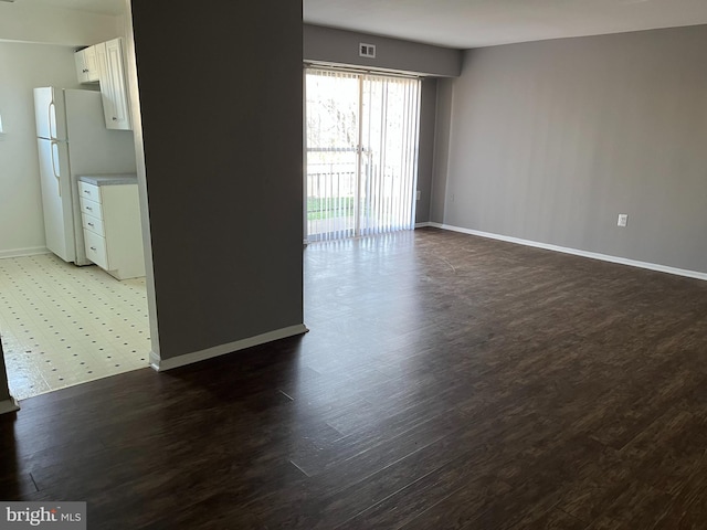 unfurnished room with dark hardwood / wood-style flooring