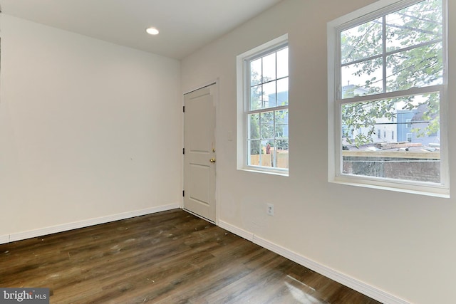 spare room featuring dark hardwood / wood-style flooring