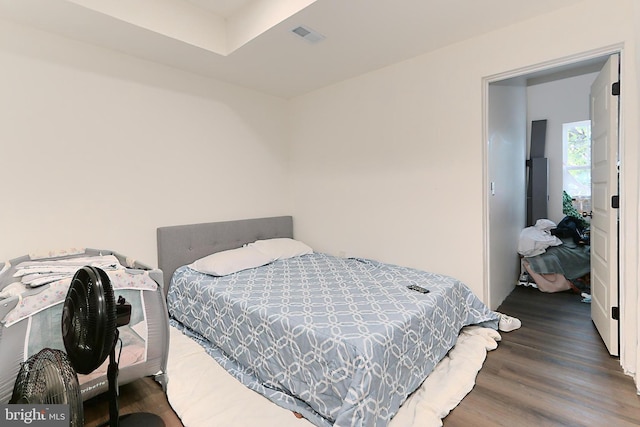 bedroom with dark wood-type flooring