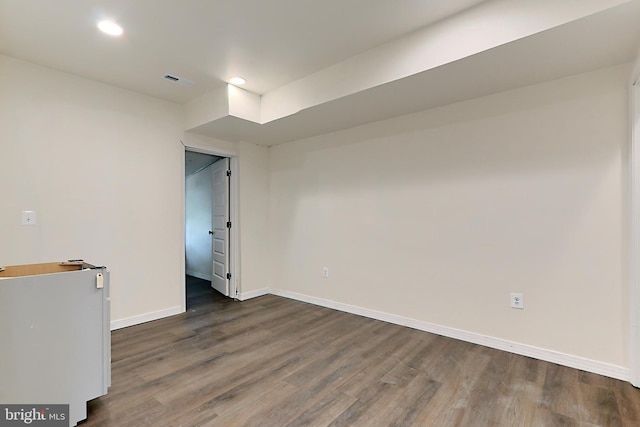 spare room with dark wood-type flooring