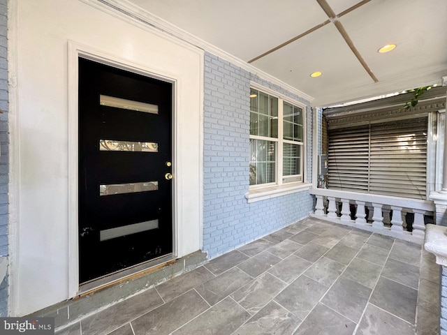 doorway to property featuring covered porch