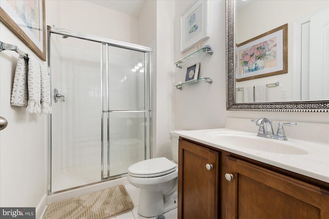 bathroom featuring a shower with door, vanity, tile patterned floors, and toilet