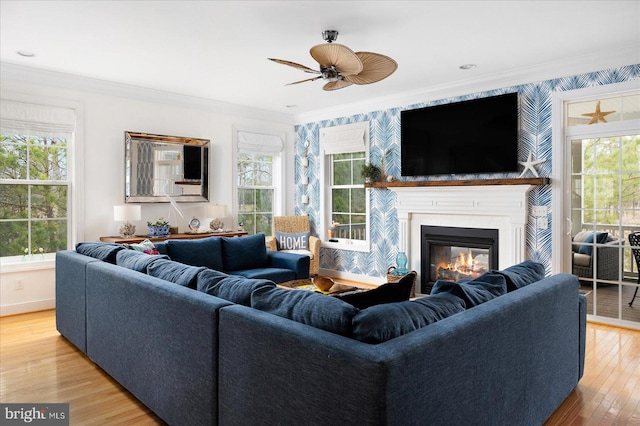 living room featuring hardwood / wood-style flooring, crown molding, and a wealth of natural light