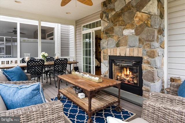 exterior space with ceiling fan and an outdoor stone fireplace