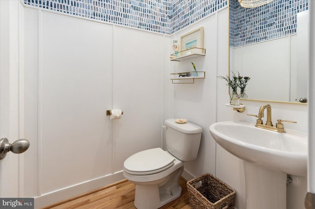 bathroom with wood-type flooring and toilet