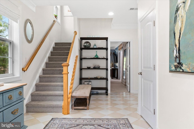 staircase featuring crown molding