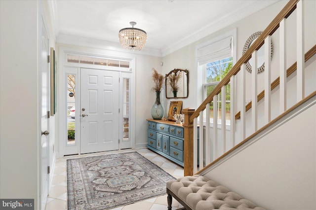 tiled entrance foyer featuring ornamental molding and a notable chandelier