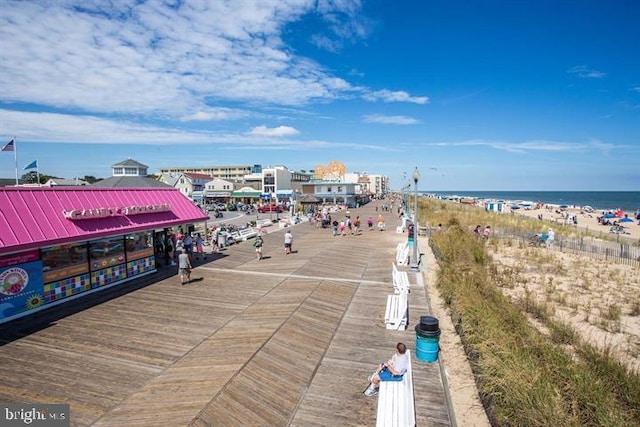 exterior space with a water view and a beach view