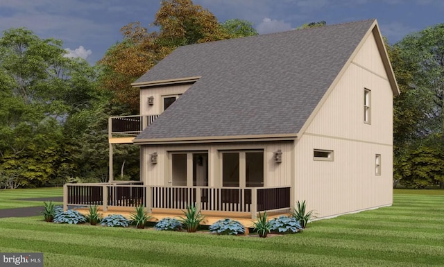 rear view of house featuring a balcony and a lawn