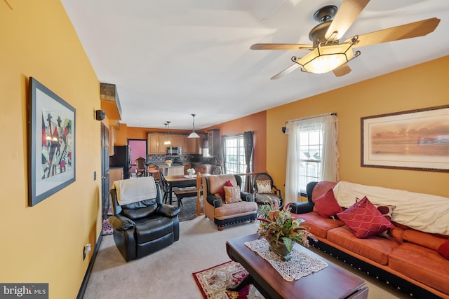 carpeted living room featuring ceiling fan