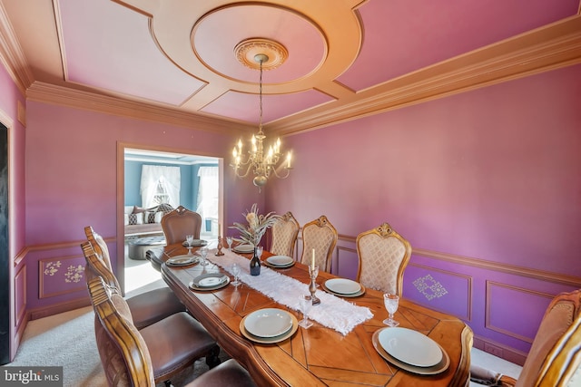 carpeted dining area featuring an inviting chandelier and crown molding