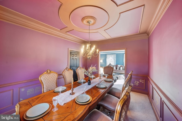 dining space featuring crown molding, a chandelier, and carpet flooring