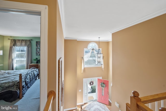 bedroom with crown molding, an inviting chandelier, and multiple windows