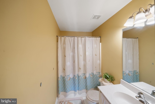 bathroom featuring vanity, toilet, and a shower with shower curtain