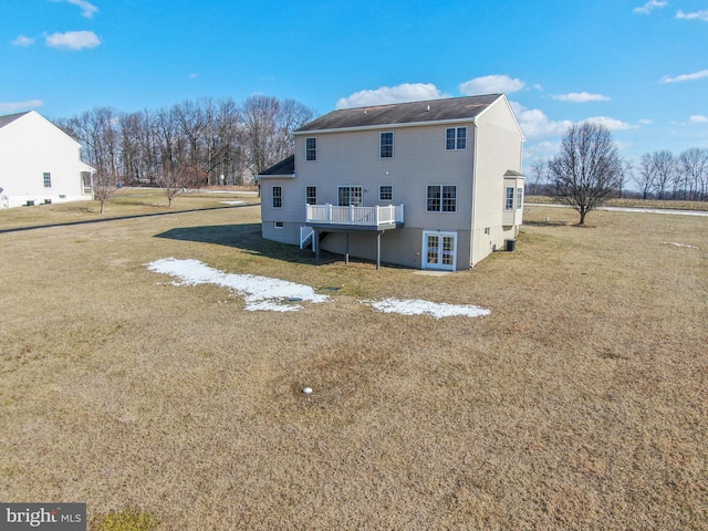 back of property featuring a yard and a deck