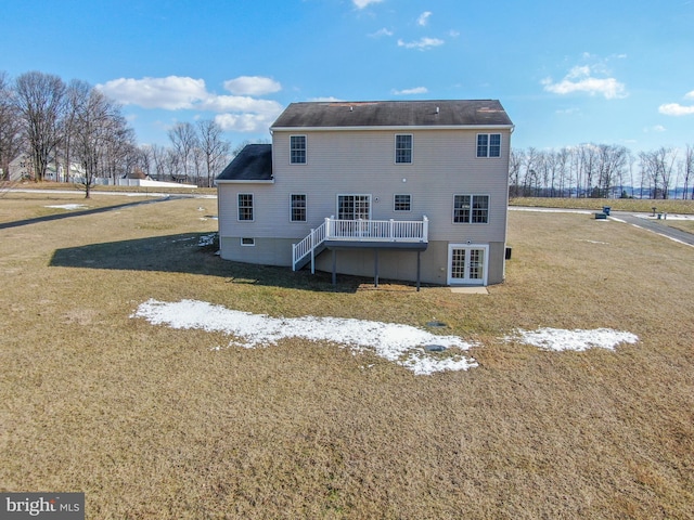 rear view of house with a yard and a deck