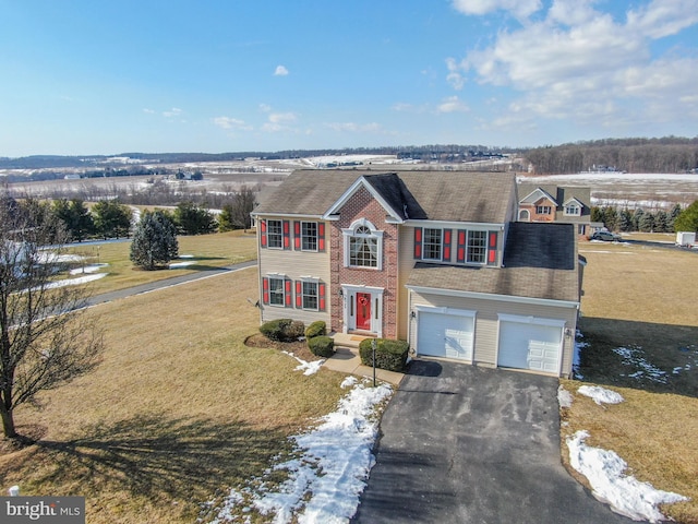 view of front of property with a garage and a front yard