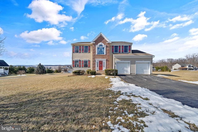 view of front of house featuring a garage and a front yard
