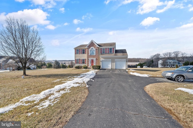 view of front of home featuring a garage and a front yard