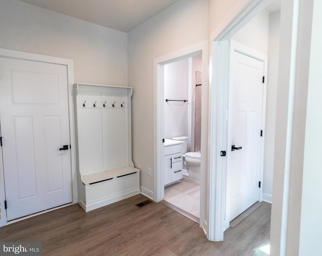 mudroom with light hardwood / wood-style floors